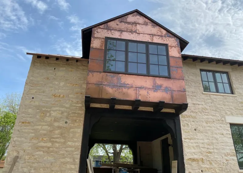 Copper metal panel facade on a stone building for Skylight Installation in Poway