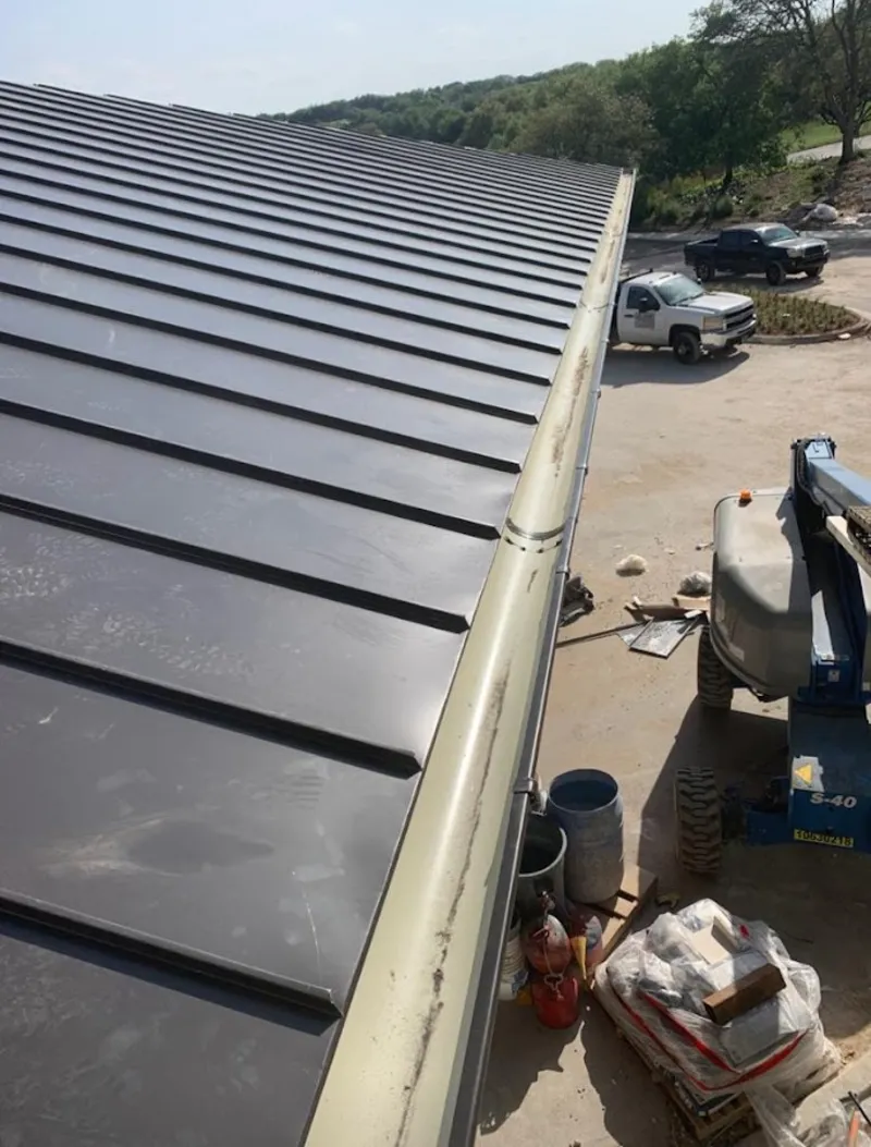 Standing seam panel and gutter detail on a metal roofing jobsite in Poway